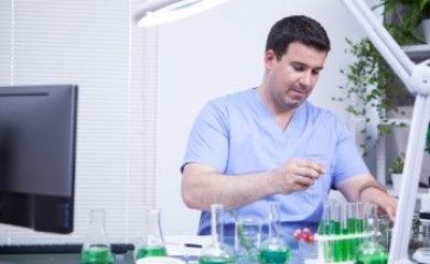 Young scientist man making test in a microbiological research lab. Quality control in a lab.