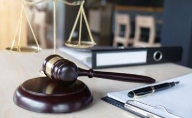 Close up of gavel and scales of justice and Report the case with paper on wooden table in office, Law and justice concept.